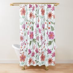 a white shower curtain with pink and green flowers on it