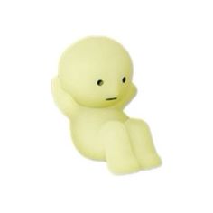 a small yellow toy sitting on top of a white surface