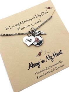 a necklace with a heart and an angel on it that says, in loving memory of my dad forever loved always in my heart