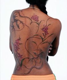 the back of a woman's body with flowers on it