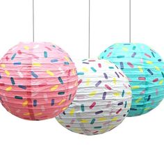 three paper lanterns with sprinkles on them