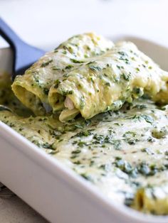 spinach and cheese stuffed ravioli in a white casserole dish