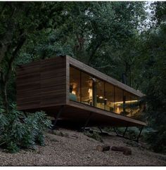 a house built into the side of a hill surrounded by trees