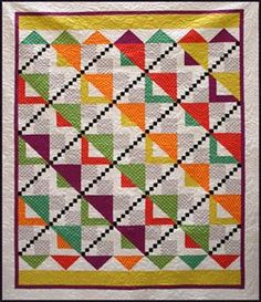 a colorful quilt is hanging on the wall