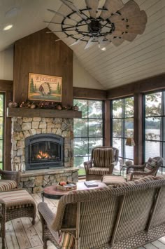 a living room filled with lots of furniture and a fire place in the middle of it