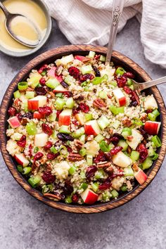 a bowl filled with rice, apples and cranberries