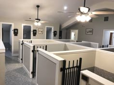 an empty room with white walls and black railings