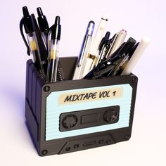 a cassette shaped pen holder filled with pens and pencils