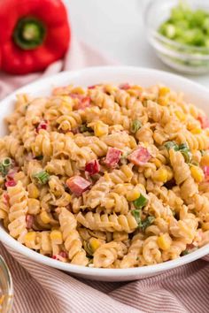 a white bowl filled with macaroni salad on top of a table