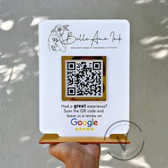 a hand holding up a qr code for someone to use on their cell phone