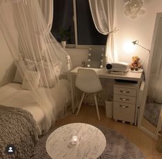 a bedroom with a bed, desk and mirror in the corner next to a window