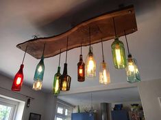 a bunch of lights that are hanging from a beam in the ceiling above a kitchen counter