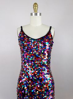 "This fun vintage party dress! It is fully embellished with rainbow paillette sequins and in excellent condition! Size SMALL Measurements: Bust - 32\" Waist - 26\" Hips - 36\" Length - 34\" Tag Size - 4 / Small (please refer to measurements) Size MEDIUM Measurements: Bust - 34\" Waist - 28\" Hips - 38\" Length - 33\" Tag Size - 6 /Medium (please refer to measurements) This dress comes from a pet-free and smoke-free home. If you would like more info or have any questions, please don't hesitate to Rainbow Hoco Dress, Fitted Sequin Dress For Festival, Fitted Sequin Dress For Carnival, Multicolor Disco Sequin Dress For Summer, Fitted Disco Sequin Fabric For Costume Party, Disco Fitted Sequin Fabric For Costume Party, Sequin Dress For Carnival Costume Party, Sequin Dress For Costume Party And Carnival, Rainbow Sleeveless Party Dress