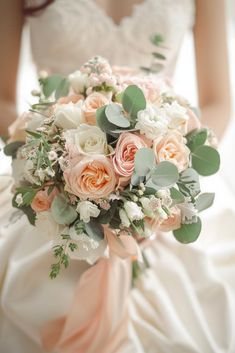 a bridal holding a bouquet of flowers and greenery