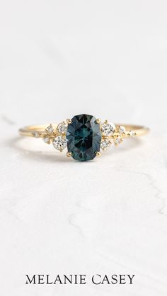 a blue diamond ring with three diamonds on the side and one stone in the middle