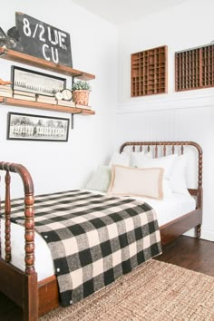 a bed sitting in a bedroom next to two wooden shelves