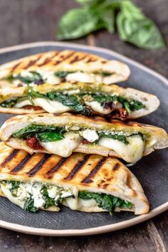 three quesadillas stacked on top of each other with cheese and spinach