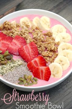 a bowl filled with granola, strawberries, bananas and other foodstuffs