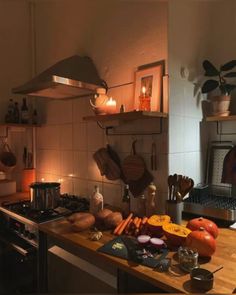 the kitchen counter is covered with vegetables and cooking utensils