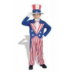 a young boy dressed in an american flag suit and top hat, standing with his hands on his head