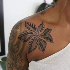 a woman with a tattoo on her shoulder