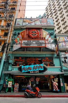 a motorcycle parked in front of a building with neon signs