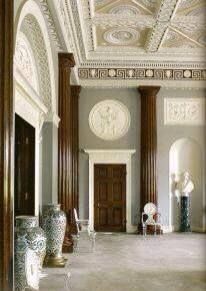 an ornate room with blue and white vases on the floor in front of it