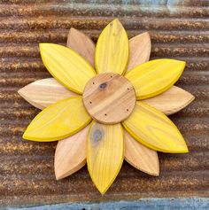 a wooden sunflower on a rusty surface