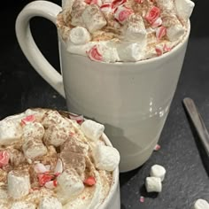 two mugs filled with hot chocolate and marshmallows