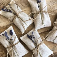 lavender sacs wrapped in burlock and tied with twine on wooden table