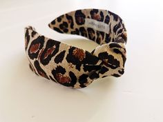 "Animal Print Top Knotted Linen Headband from Homesite Up your style with our knotted headband that is oh so chic in leopard linen. This thick headband adds casual sophistication to any outfit. Plus, you can opt to get the matching scrunchie to complete the look! FEATURES ⚬ Made of 100% linen fabric in leopard. ⚬ Adult size, measures approx. 5.5 x 6.5 inches (14 x 16.5 cm). ⚬ Option to purchase headband alone or with matching scrunchie. ⚬ Free worldwide shipping. ⚬ Lovingly handmade in beautiful Thick Headbands, Print Top, Leopard Top, Top Knot Headbands, Headbands For Women, Knot Headband, Top Knot, Support Handmade, Style Expert