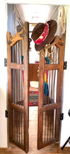 two wooden doors open with hats on them