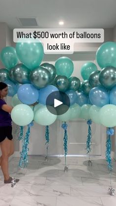 a woman is standing in front of balloons