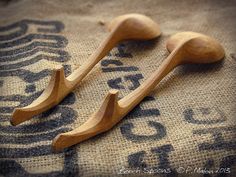 two wooden spoons sitting on top of a cloth