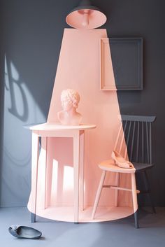 a pink table and chair in a room