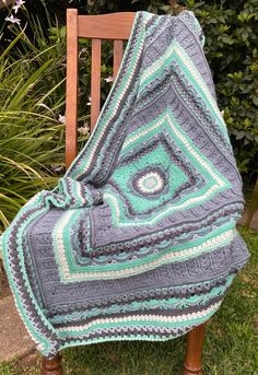 a blanket sitting on top of a wooden chair