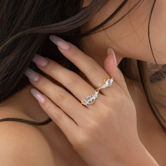 a close up of a woman's hand with a ring on her finger