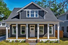 a gray house with white trim and windows