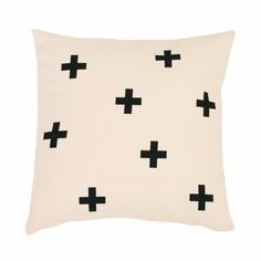 a white pillow with black crosses on it