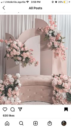 a chair decorated with pink flowers and greenery