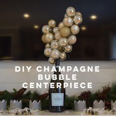 a bottle of champagne sitting on top of a table next to christmas decorations and presents