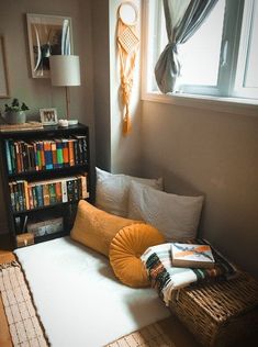 a living room with a couch, bookshelf and window