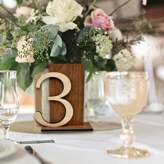 the table is set with white and pink flowers