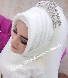 a woman wearing a white hijab with a tiara on top of her head