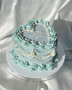 a heart shaped cake on a clear plate