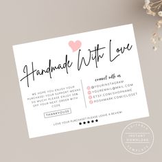 the handmade with love business card is displayed on a table next to some flowers