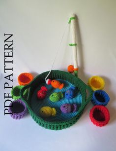 a crocheted basket with colorful objects on it