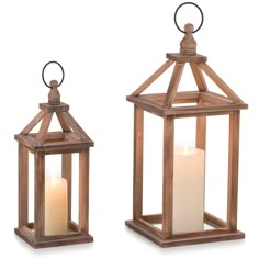 two wooden lanterns with one lit candle and the other on top of eachother