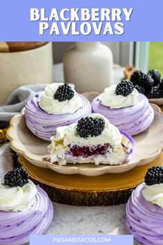 blackberry pavlovas with white frosting and blackberries are on a plate