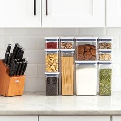 the kitchen counter is organized with containers and utensils for spices, cereals, nuts, and other ingredients